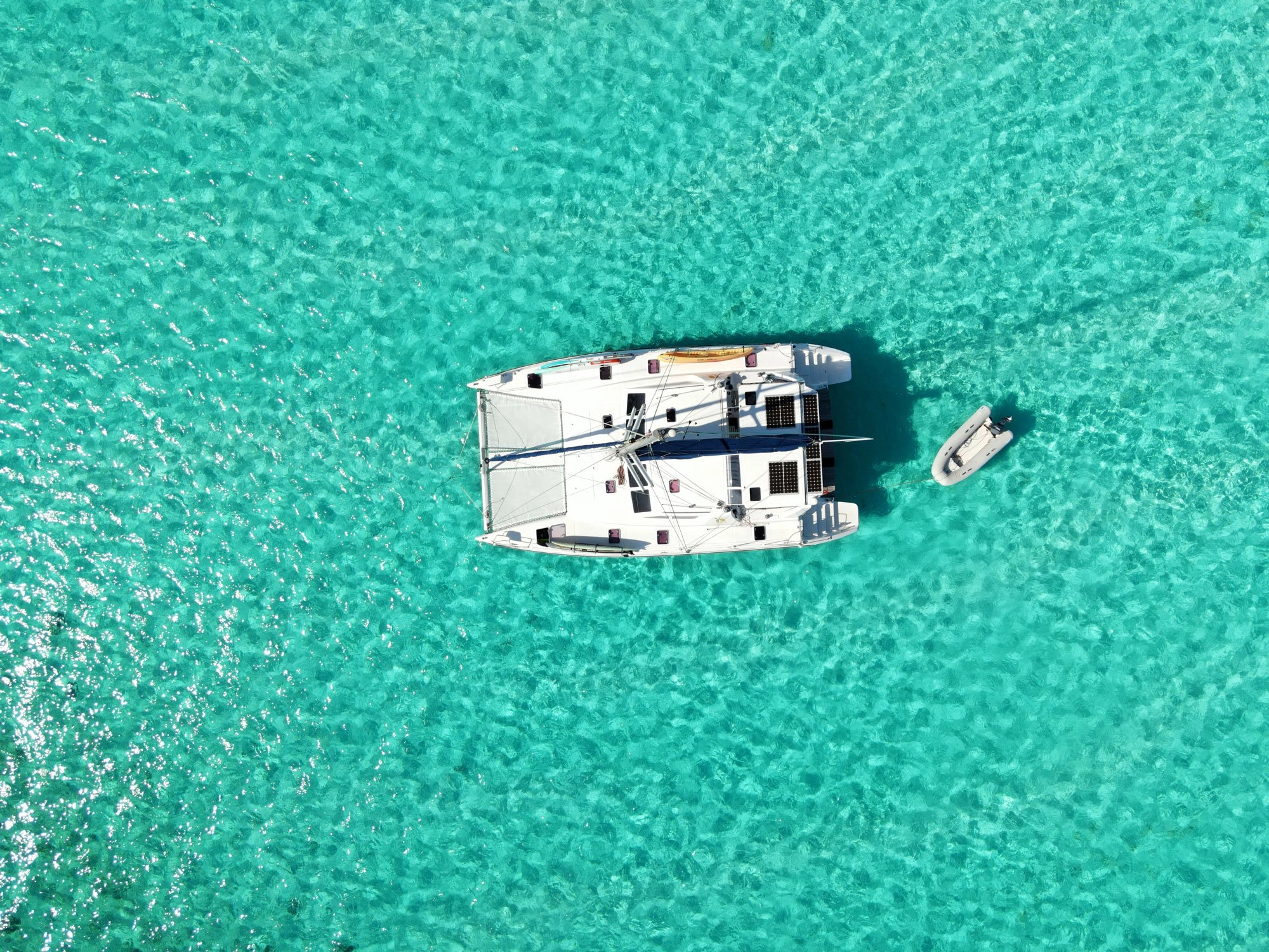 aerial-horizontal-farmers Aerial of Ocean Adventure Cat anchord in clear water over white sand in the Exumas