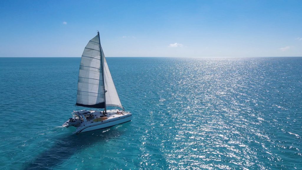 Tahina under sail catamaran under sail in calm blue waters